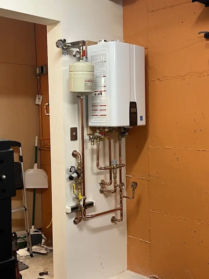Plumbing technician inspecting water heater connections in Lincolnshire